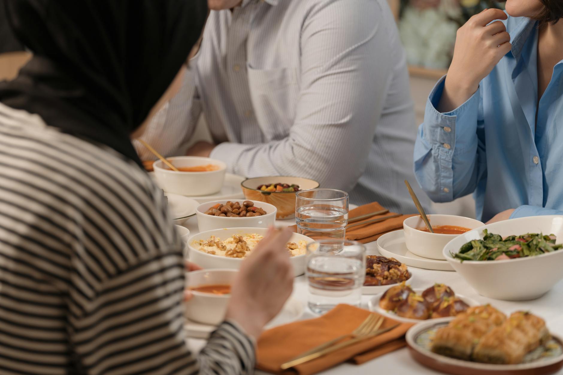 Diverse friends sharing a healthy meal at a long table